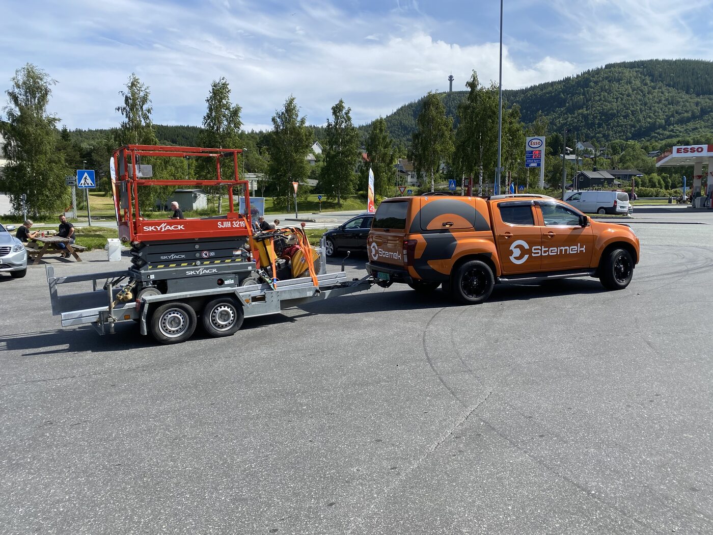 Stemek-pickup med utstyr i sommerlandskap
